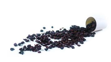 Dark, dried coffee bean husks on a white background, highlighting the rough texture and deep color, suitable for themes related to coffee production and processing. photo