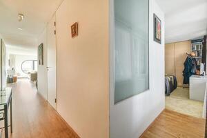 A hallway with a door and a bed in it photo