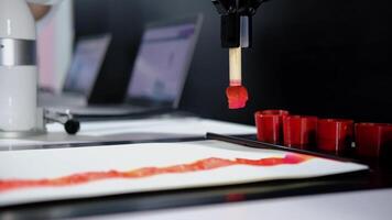 Robotic arm precisely applies red paint to a canvas, creating a visually captivating display of art and technology video