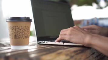 Hand typing on laptop keyboard. Working at the coffee shop video