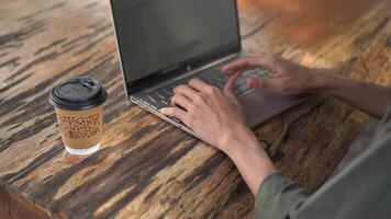 Hand typing on laptop keyboard. Working at the coffee shop video