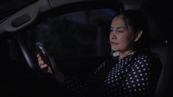 Woman is sitting in the driver's seat using a touch display screen multimedia device in car driven. holding mobile phone driving car, feeling uncomfortable, unhappy, depressed and anxious. video