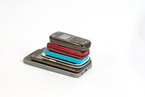 stack of mobile phones photographed close up from a side angle with isolated background photo