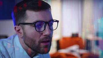 Trader investor broker in eyeglasses and formal wear working with pc while sitting in his office in front of computer screens with trading charts video