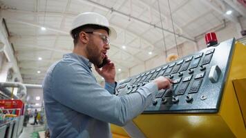Engineer entering data in CNC machine at pvc window factory to get the production going video