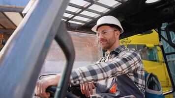 Portrait of smiling warehouse worker operating a forklift loader video