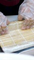 process of preparing sushi with vegetables Close-up of process of making sushi, roll with seafood on wooden desk video