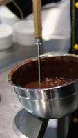 add flour to brownie batter Step by step the process of making Chocolate cakes.Woman's hands mix eggs and butter using a mixer. Processes of preparation of chocolate brownies close-up on the table. video
