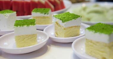 pistachio sponge cake at the buffet table sprinkled with green freeze-dried pistachio berries video