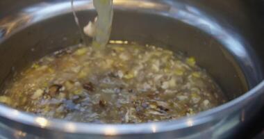 seafood soup thick slimy soup scoop with a ladle lift flows like snot. finely chopped mushrooms in slime soup video