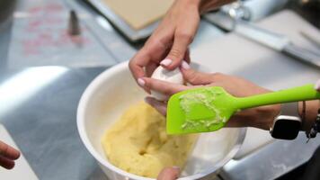 Choux pastry for eclairs. Making small eclairs with help of pastry bag. Piping choux dough for eclairs on baking paper. Slow motion. video