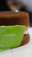 Using a palette knife, decorate a bento cake with a flower made of cream. Selective focus. video