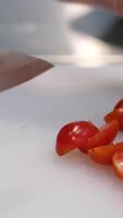 Cooking a salad of cherry tomatoes, feta cheese and arugula microgreens. Chef cuts cherry tomatoes. Vegan food. Summer refreshing salad. Top view. video