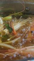 Hot pot is a traditional Chinese fire pot stew also known as steamboat dish in which a heat source is placed on the dining table. keeps a pot of broth on low heat video