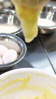 Choux pastry for eclairs. Making small eclairs with help of pastry bag. Piping choux dough for eclairs on baking paper. Slow motion. video