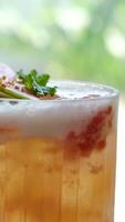 cold lemonade summer cocktails from guava and orange on the table near the window there are drinks with ice with a straw with dried fruits and mint video