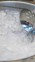 crushed ice for drinks Use a large ladle to scoop ice for drinks from an iron bowl at the buffet table video