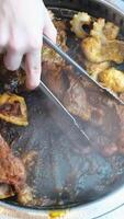 barbecue new meat with seasonings is being prepared in a cafe for dinner lunch Vietnam fry meat in a frying pan on a table in a restaurant video