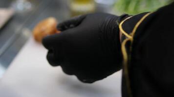 bake profiteroles profiteroles, which the confectioner prepares for filling with custard, are placed on a dish. Female hands of a confectioner start with eclairs. video