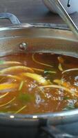 broth with vegetables Stirred ladle chicken with noodles and potatoes cold soup in a small saucepan on the gas stove near the window video