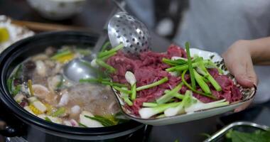Hot pot is a traditional Chinese fire pot stew also known as steamboat dish in which a heat source is placed on the dining table. keeps a pot of broth on low heat video