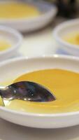 Top view of tasty creme brulee dessert with caramel crust served in ramekin on table with sunlight video