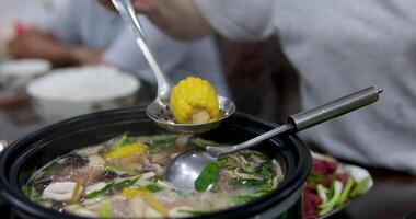 Hot pot is a traditional Chinese fire pot stew also known as steamboat dish in which a heat source is placed on the dining table. keeps a pot of broth on low heat video