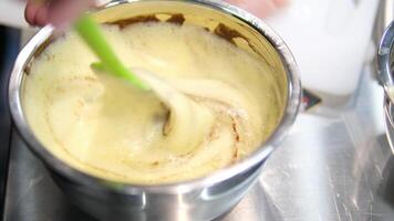 add flour to brownie batter Step by step the process of making Chocolate cakes.Woman's hands mix eggs and butter using a mixer. Processes of preparation of chocolate brownies close-up on the table. video