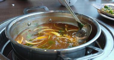 broth with vegetables Stirred ladle chicken with noodles and potatoes cold soup in a small saucepan on the gas stove near the window video