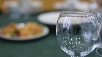 dinner lunch empty glass food on table table setting with flowers and green tablecloth video