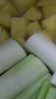 leeks and potatoes in a saucepan making french onion soup Traditional vegetables soup, slices and pieces of freshly cut vegetables of carrot, onion, potato, zucchini, courgette and peas video
