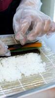 process of preparing sushi with vegetables Close-up of process of making sushi, roll with seafood on wooden desk video