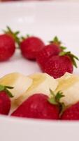 put strawberries and bananas with a heart Cooking strawberry and banana milkshake or smoothie in blender. Pouring ripe fruits in blender. Slow motion. Healthy drink concept video