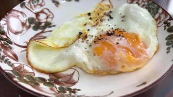 close-up in a frying pan chicken egg is fried, oil splashes scrambled eggs cooking. macro, breakfast of fried eggs, selective focus. scrambled eggs in a pan.quick light breakfast with protein video