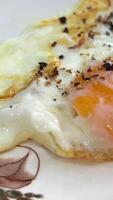 close-up in a frying pan chicken egg is fried, oil splashes scrambled eggs cooking. macro, breakfast of fried eggs, selective focus. scrambled eggs in a pan.quick light breakfast with protein video