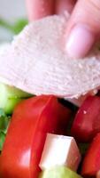 add meat to salad Delicious salad with fried chicken, blue cheese, strawberries and walnuts. Presentation of the dish. Rotating and moving the camera. Adding ingredients, decoration. video