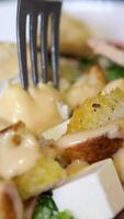salad with mustard sauce. pick up salad with cheese pieces using a fork video