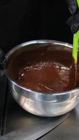add flour to brownie batter Step by step the process of making Chocolate cakes.Woman's hands mix eggs and butter using a mixer. Processes of preparation of chocolate brownies close-up on the table. video