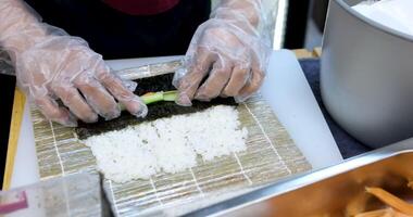 process of preparing sushi with vegetables Close-up of process of making sushi, roll with seafood on wooden desk video
