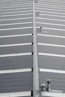 Monochrome view on industrial rooftop with geometric patterns created by the alignment of corrugated metal sheets. photo