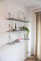 A shelf with plants and a book on it photo