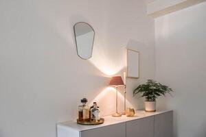 A small sideboard with a mirror and a lamp photo