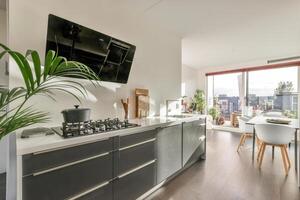 A kitchen with a large window and a large tv photo