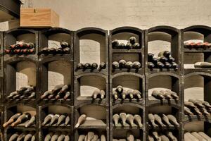 A wine rack with many bottles on it photo