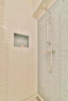 A shower with a shower head and a shower stall photo