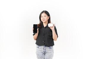 Online shopping concept. asian woman holding credit card and smartphone app, buying, order delivery in mobile phone application, standing over white background photo