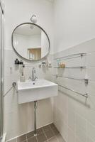 A bathroom with a sink and mirror photo