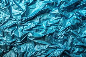 Tropical blue foil texture with a wrinkled and then smoothed background surface captured from an aerial perspective, undulating, metallic, decorative, tranquil, background, reflective photo