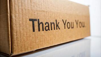 close-up, words, packaging, A close up shot of a cardboard box texture with the words Thank You written on it captured from a worm s eye view against a plain white background photo