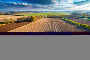 beginning, rural, agriculture, An aerial view of an expansive empty plowed field at the beginning of the spring season with rows of rich soil waiting to be planted and nurtured photo